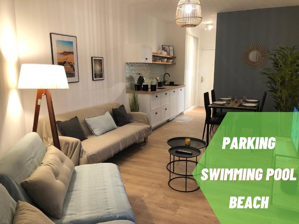 a living room with a couch and a dining room at Studio bord de mer - Piscine - Plage in San-Nicolao