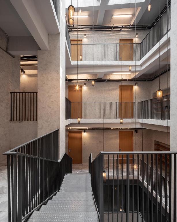 a view of the lobby of a building with stairs at Luk Hostel in Bangkok