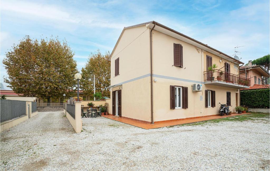 a large white house with a fence and a yard at La Ghiaia in Lido di Camaiore