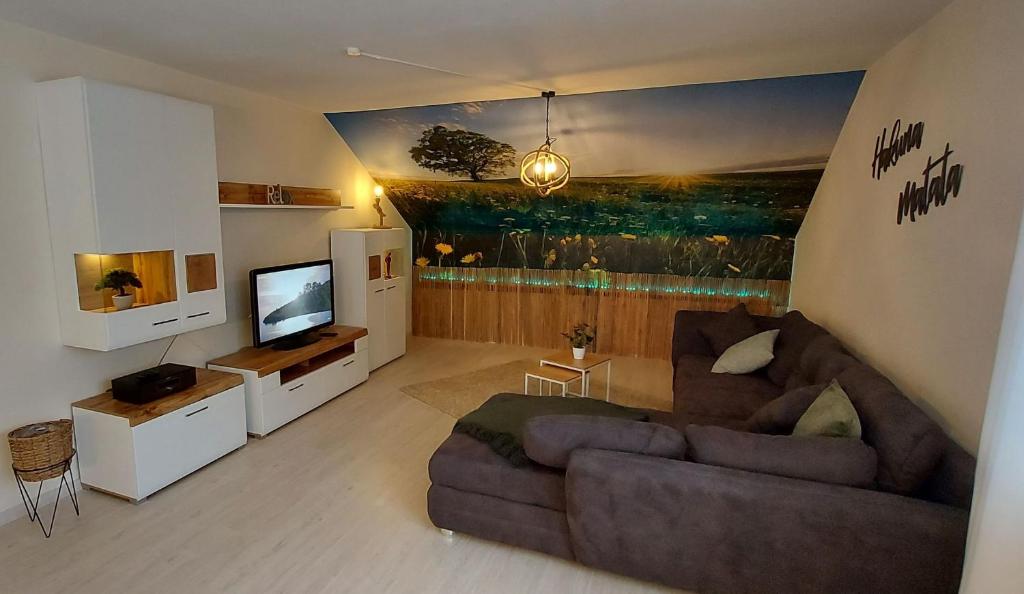 a living room with a couch and a television at Fewo Diego in Winterberg