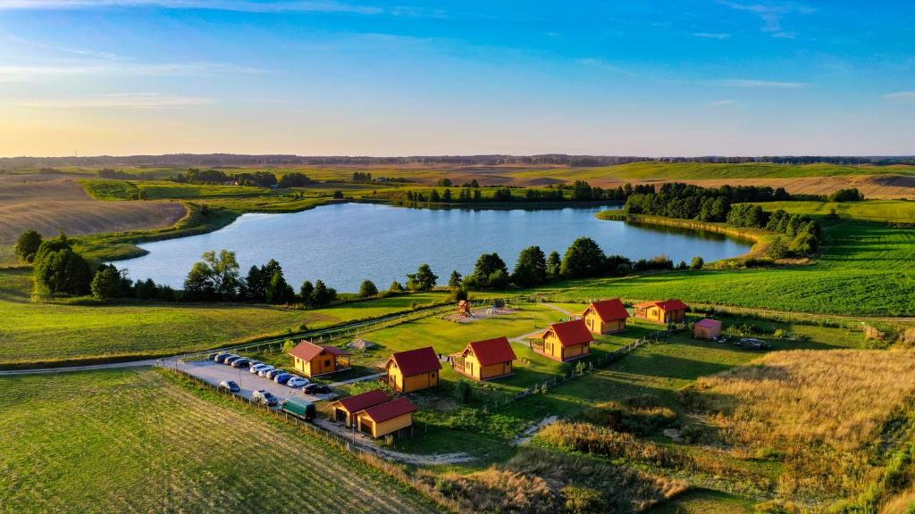 an aerial view of a farm with a lake at Ostoja Rodzinna in Giżycko