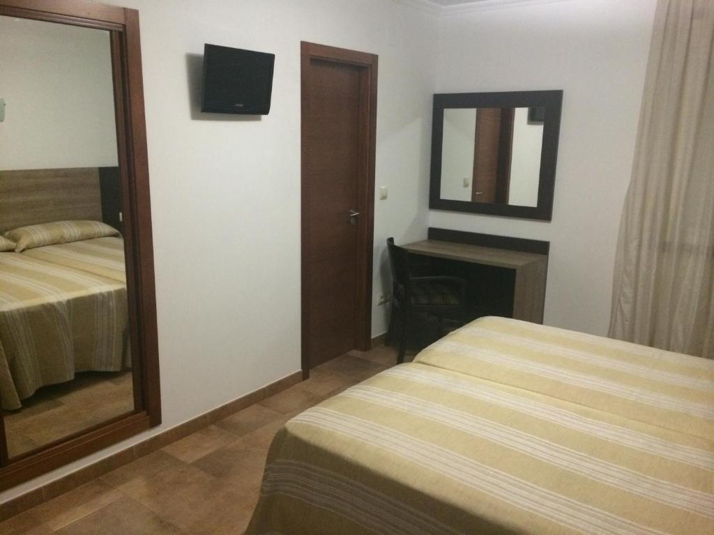 Posteľ alebo postele v izbe v ubytovaní Hostal Eden