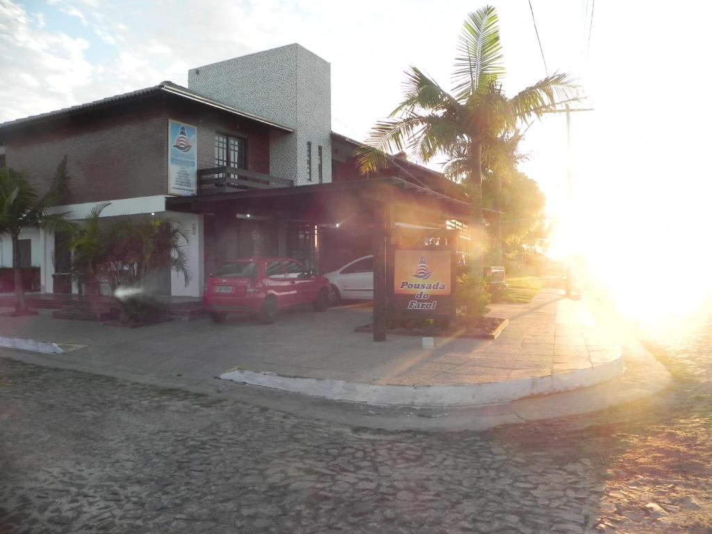 a building with a car parked in front of it at Pousada Do Farol in Capão da Canoa