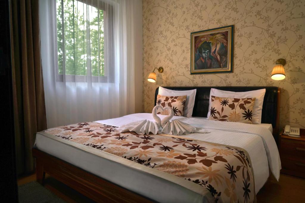 Postel nebo postele na pokoji v ubytování Hotel Iris