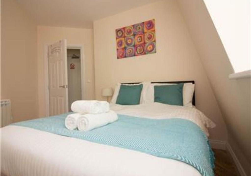 a bedroom with a bed with towels on it at StayZo Serviced Accommodation 16 Premier Lodge in Southampton