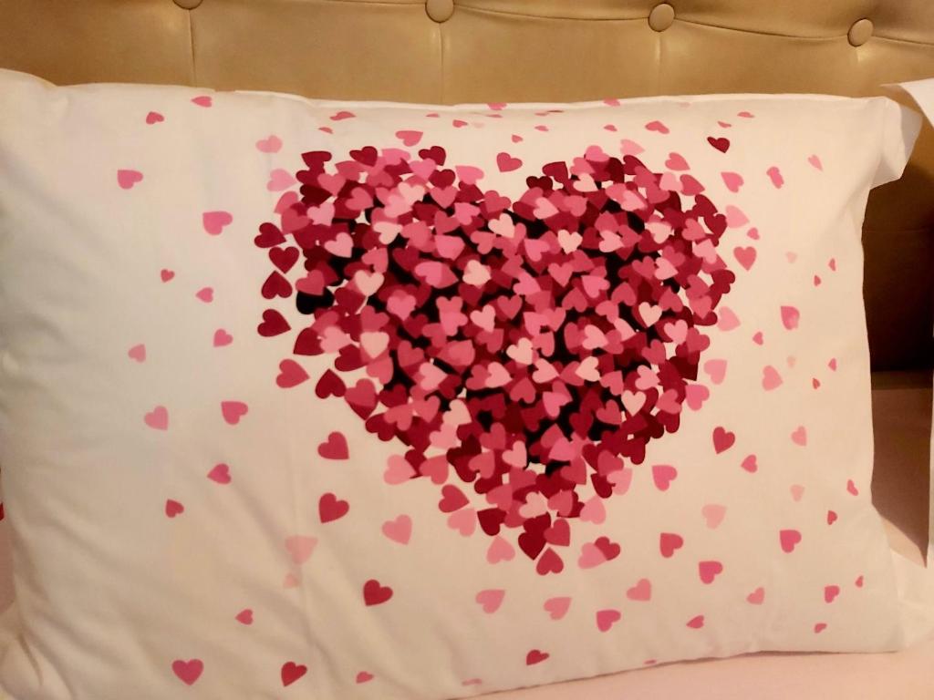 a pillow with a heart made out of hearts at Amore@Tivat in Tivat