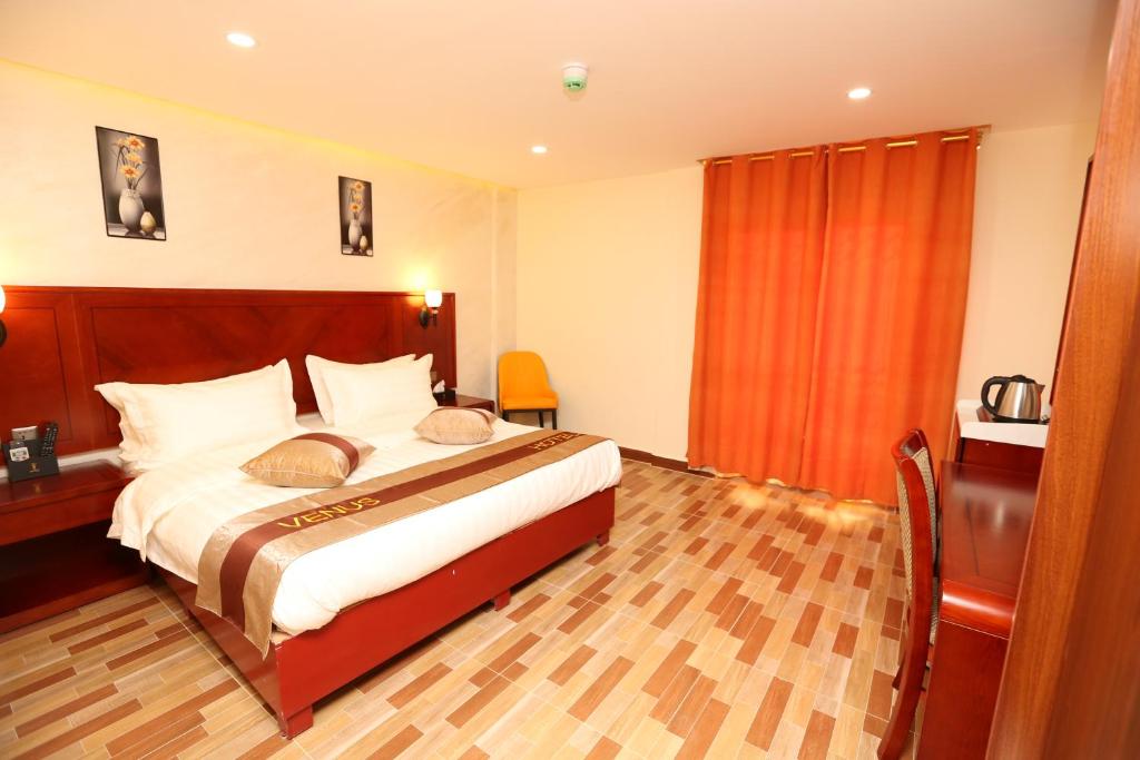 Postel nebo postele na pokoji v ubytování Venus Hotel