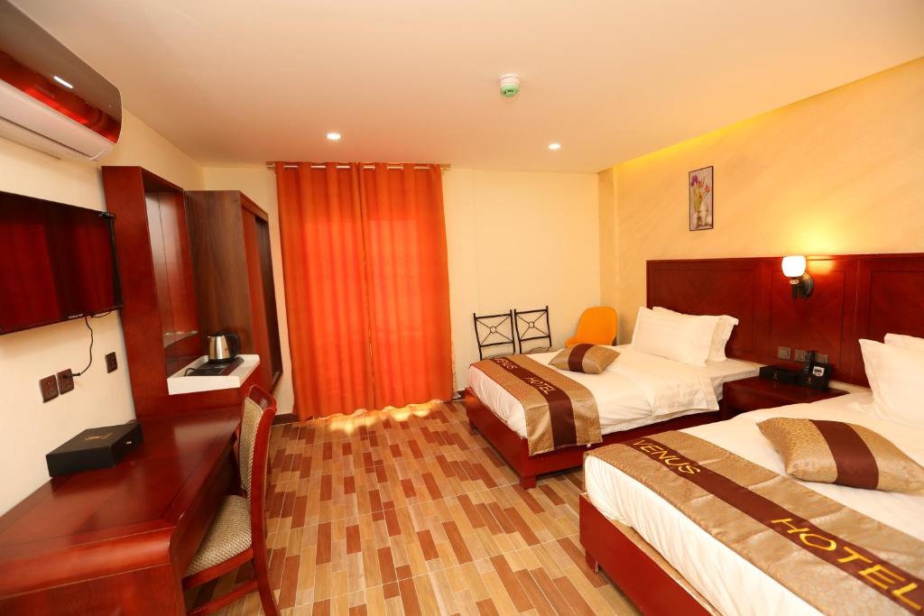 Postel nebo postele na pokoji v ubytování Venus Hotel