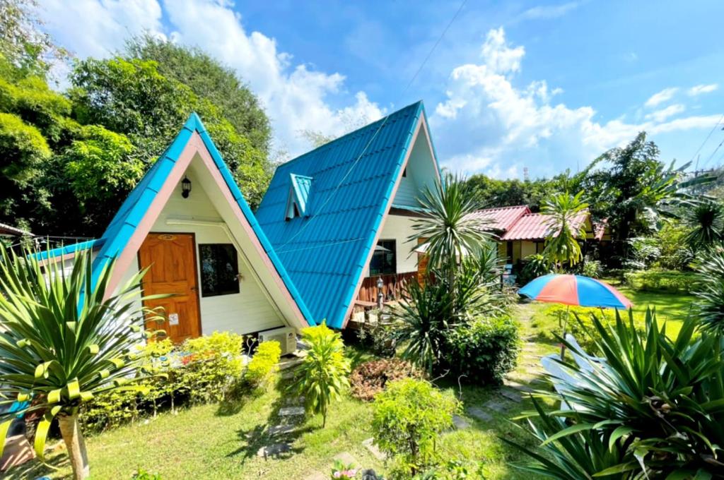 a small house with a blue roof at Star View Garden in Sai Yok