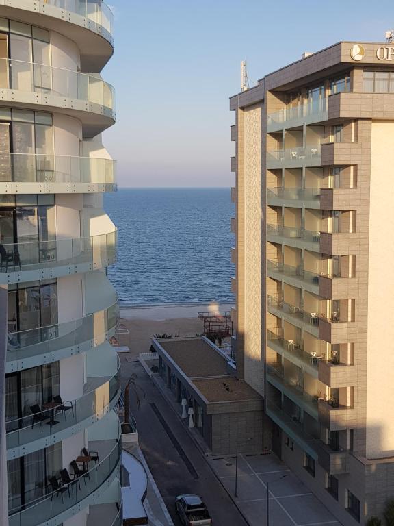 a view of the ocean from between two buildings at 911 Cazare Mamaia in Mamaia