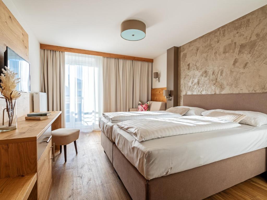 Posteľ alebo postele v izbe v ubytovaní Stadthotel EGGERBRÄU