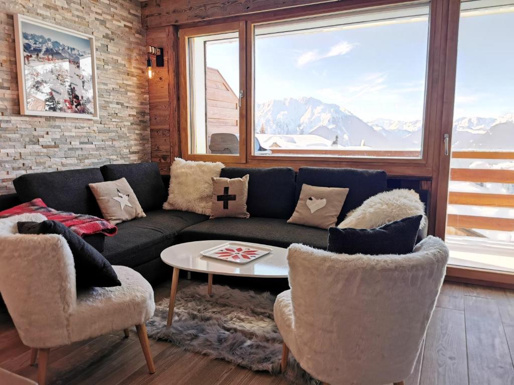 a living room with a couch and two chairs at Verbier Medran + Private Sauna in Verbier