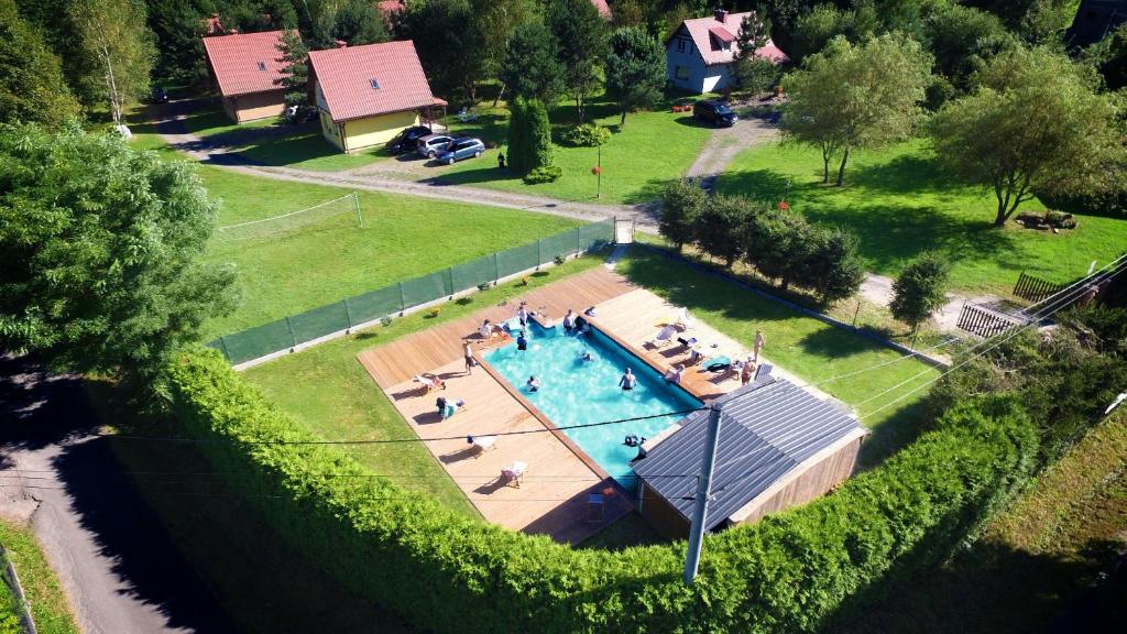 an overhead view of a swimming pool with people in it at chatkiagatki in Polańczyk