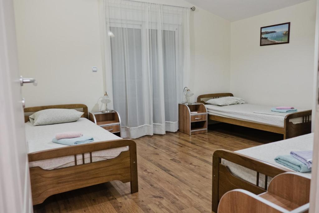 Postel nebo postele na pokoji v ubytování Apartments Klara
