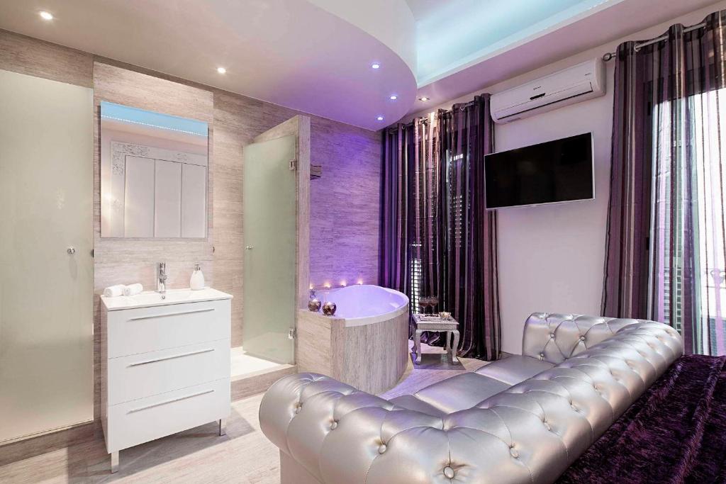 a bathroom with a bath tub and a sink at Romantic Barcelona Apartment in Barcelona