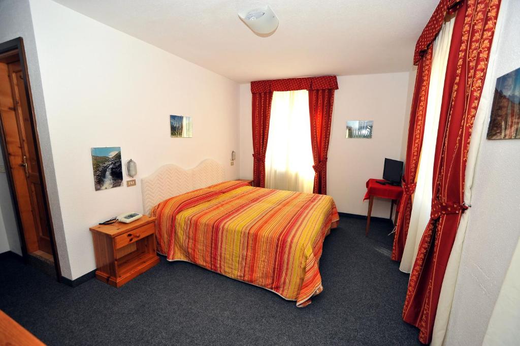 Postel nebo postele na pokoji v ubytování Hotel Capitani