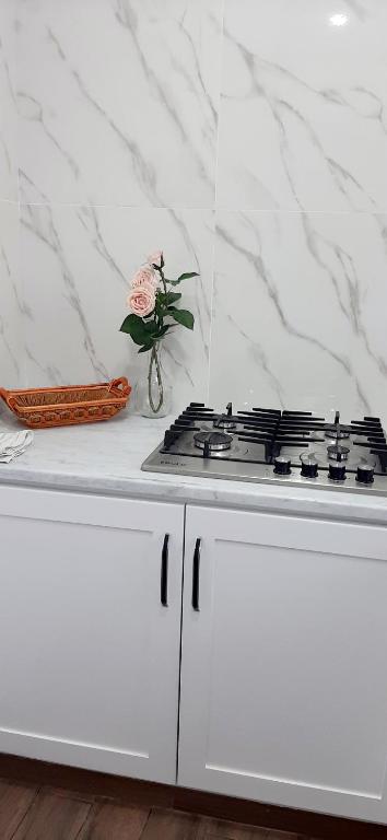a white counter with a stove top in a kitchen at TIM Haute standing appartment S2, center Monastir in Monastir