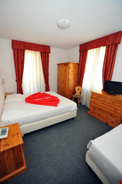 Postel nebo postele na pokoji v ubytování Hotel Capitani