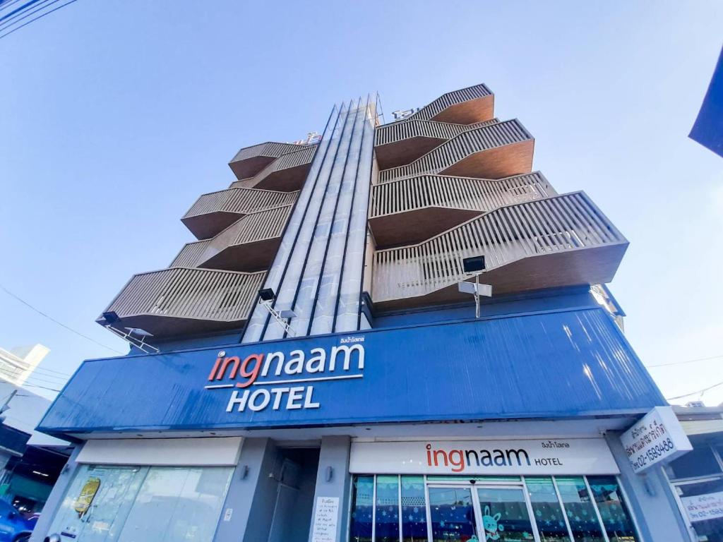 a building with a hotel on top of it at Ingnaam Hotel in Ban Talat Rangsit