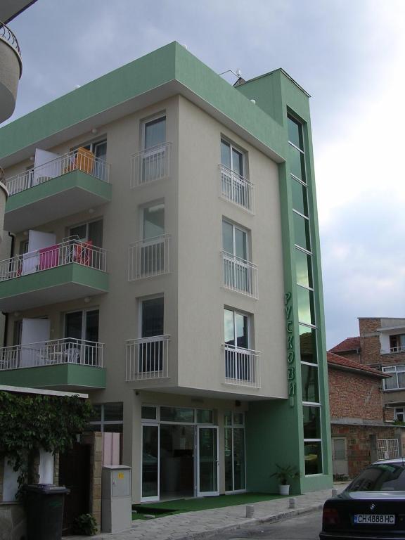 a building with balconies on the side of it at Guesthouse Ruskovi in Ravda