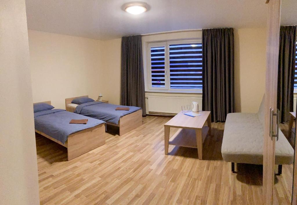 a hospital room with two beds and a window at Motelis Astarte in Koknese