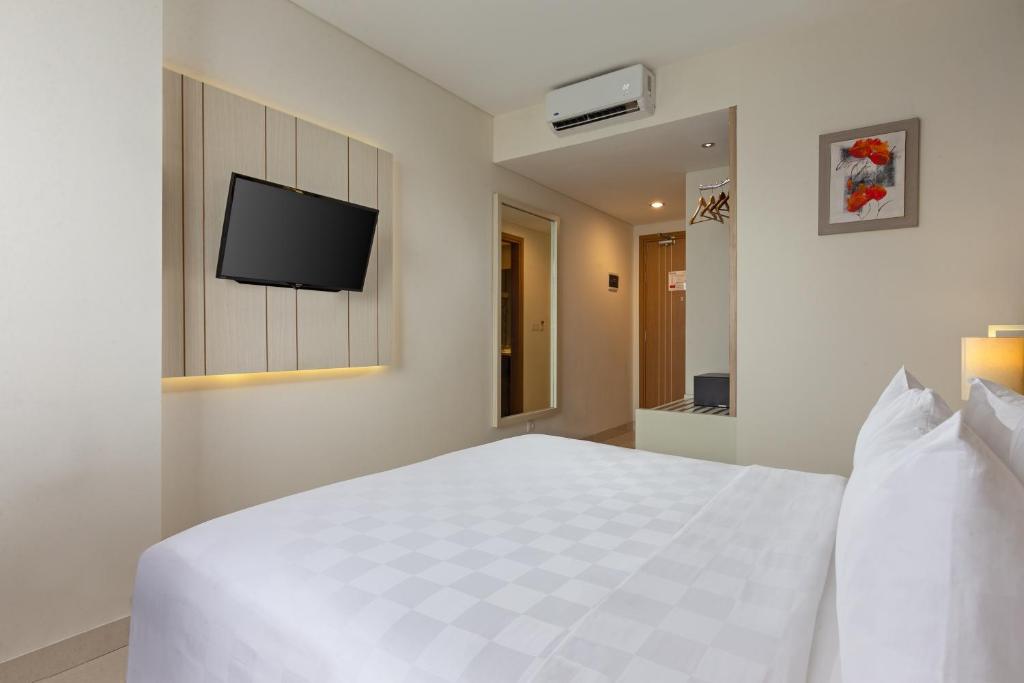 Postel nebo postele na pokoji v ubytování Swiss-Belinn Gajah Mada Medan
