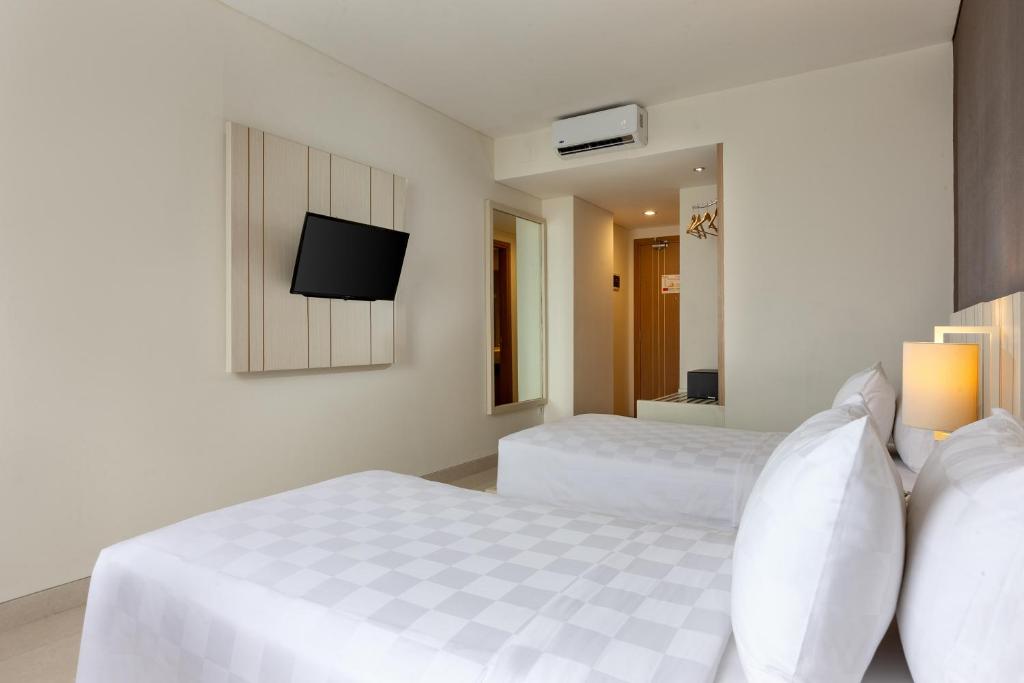 Postel nebo postele na pokoji v ubytování Swiss-Belinn Gajah Mada Medan