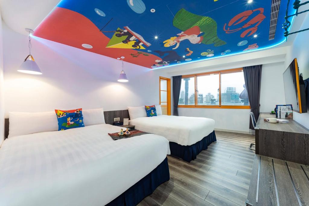 a hotel room with two beds and a mural on the ceiling at Norway Forest Travel hotel 1 Taichung in Taichung