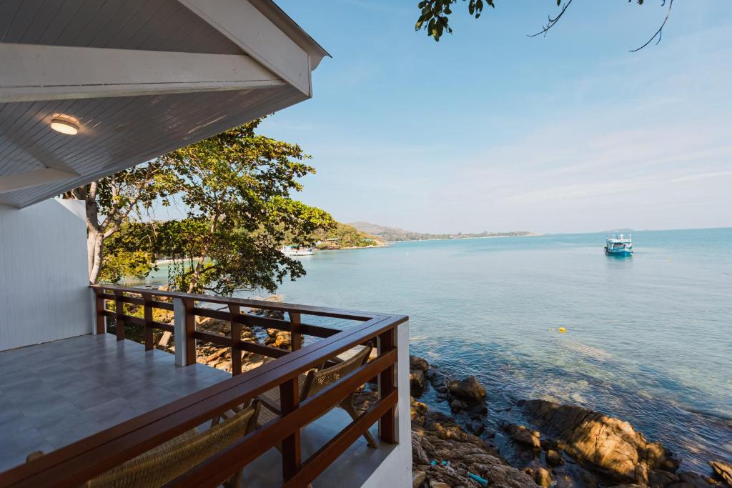 a balcony of a house with a view of the water at Vimarn Samed Resort in Ko Samed