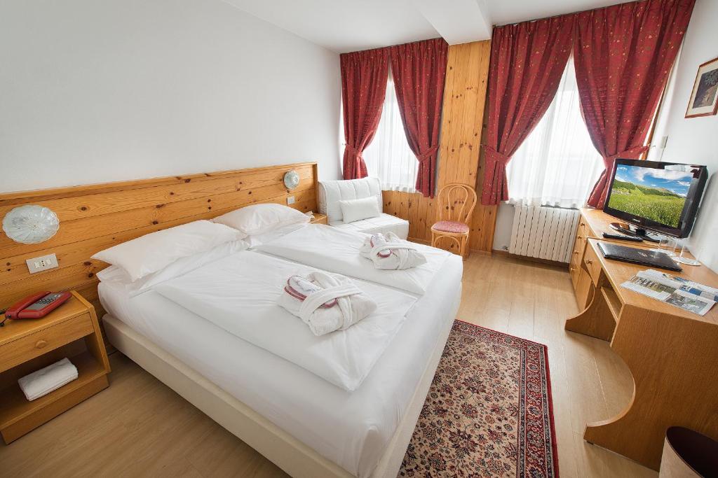 Postel nebo postele na pokoji v ubytování Hotel Livigno