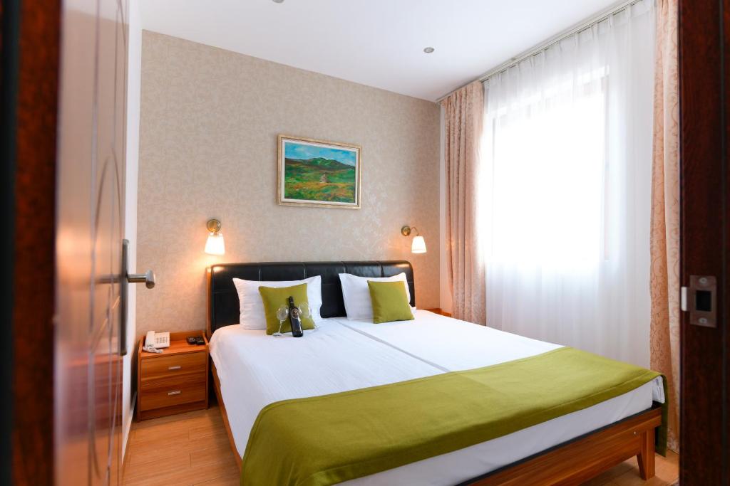 Postel nebo postele na pokoji v ubytování Hotel Iris
