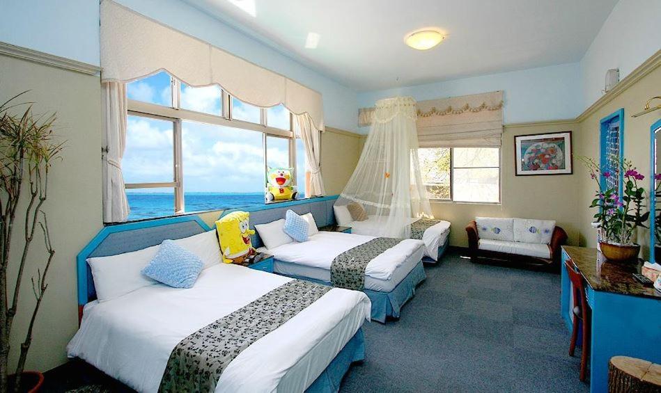 a hotel room with two beds and a window at Sunny Ocean B&B in Yanliau