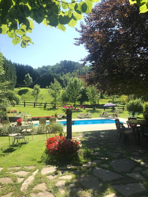 a garden with a swimming pool in a park at Agroturismo Anziola in Oiartzun