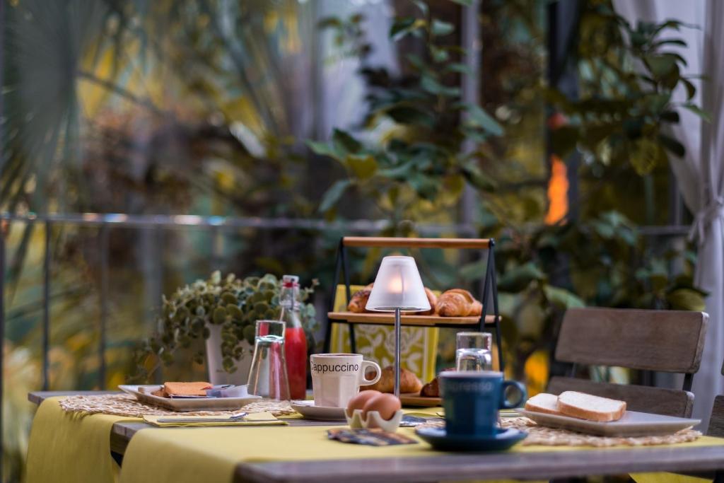 a table with a yellow table cloth and food on it at La Corte sul Naviglio in Boffalora sopra Ticino