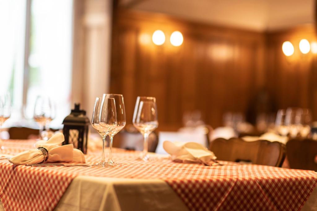 a table with two wine glasses sitting on it at Hotel Schweizerhof in Engelberg