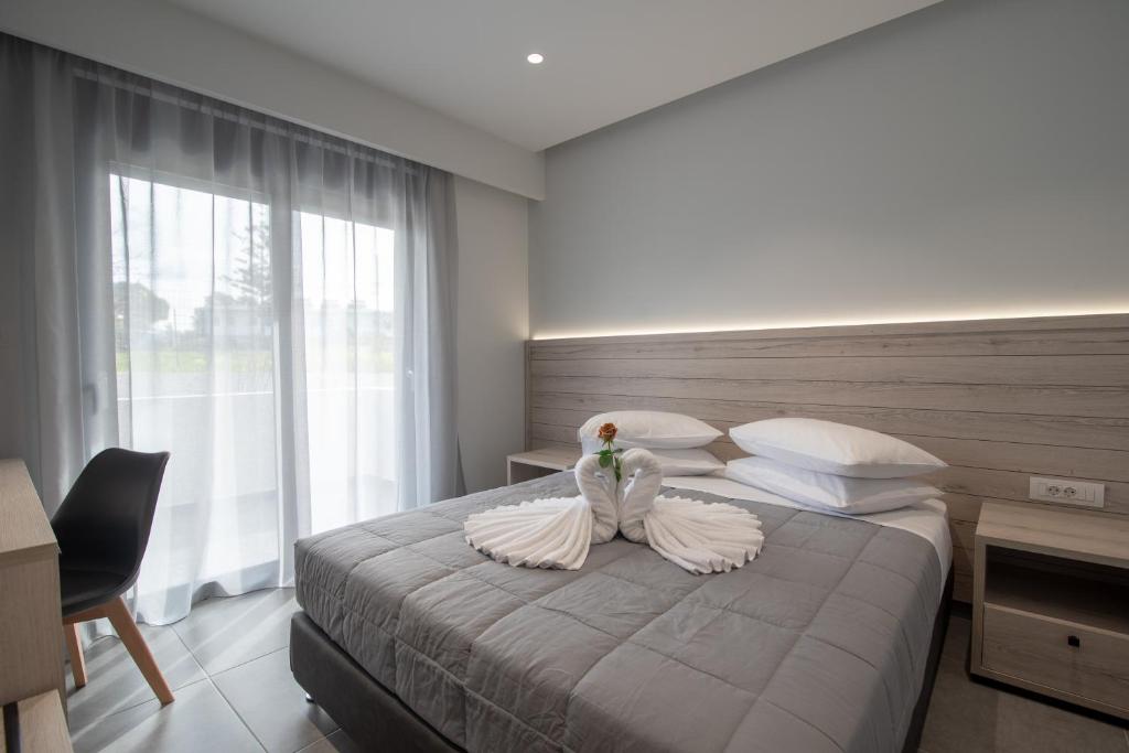 a bedroom with a bed with a swan decoration on it at NM Apartments in Mastichari