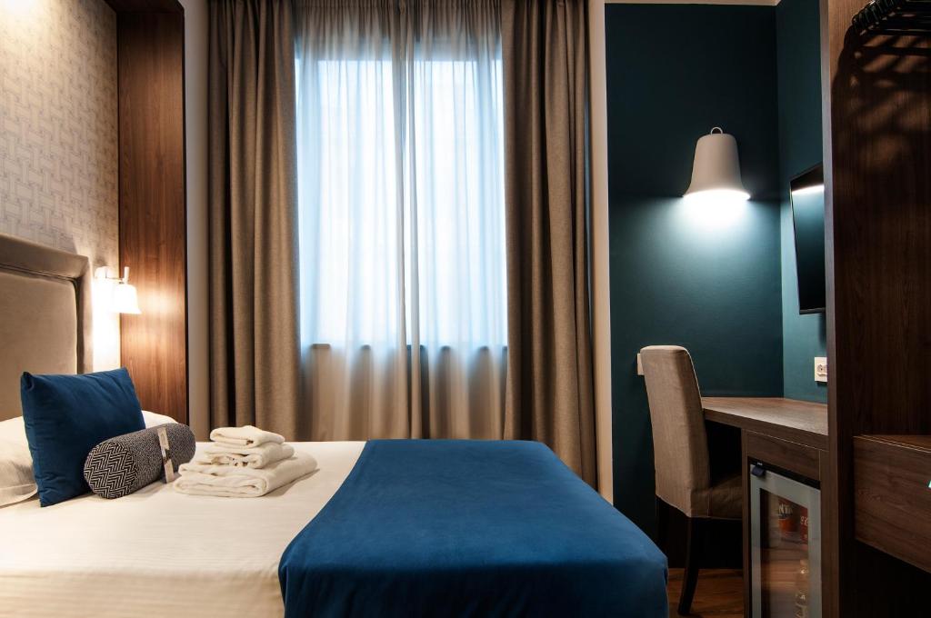 Postel nebo postele na pokoji v ubytování Fly Decó Hotel