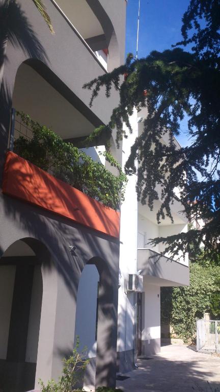 a building with a flag on the side of it at Apartments Villa Ivanka in Podstrana