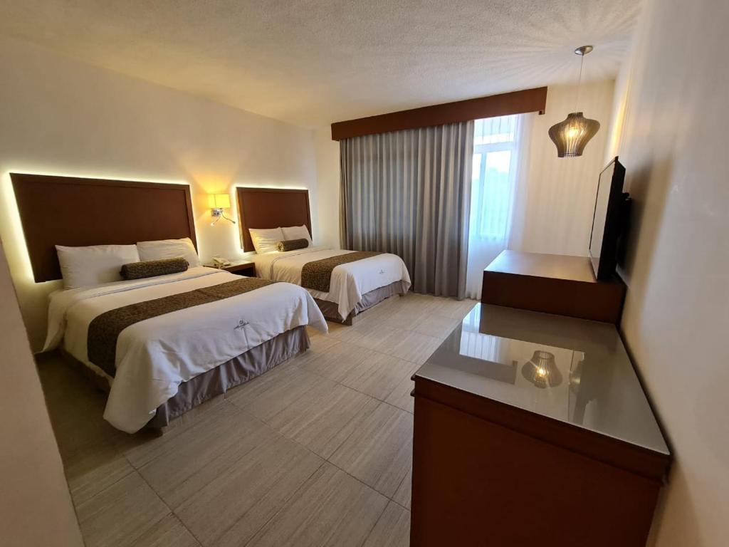 Postel nebo postele na pokoji v ubytování Hotel Marlon