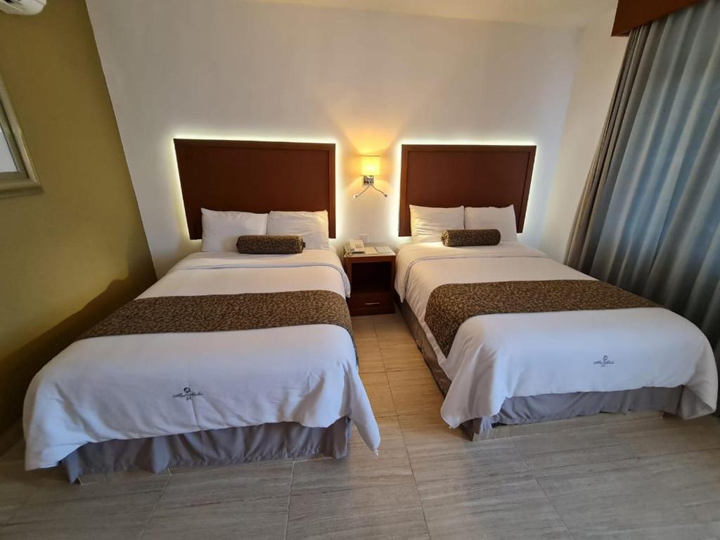 Postel nebo postele na pokoji v ubytování Hotel Marlon