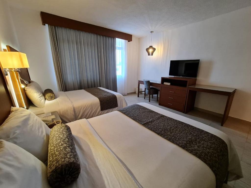 Postel nebo postele na pokoji v ubytování Hotel Marlon