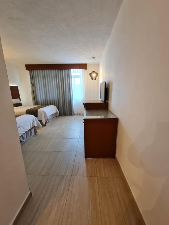Postel nebo postele na pokoji v ubytování Hotel Marlon