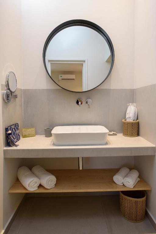 a bathroom with a sink and a mirror at Vigla Hotel in Aegiali