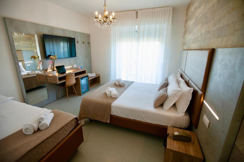 Postel nebo postele na pokoji v ubytování Hotel Maestri