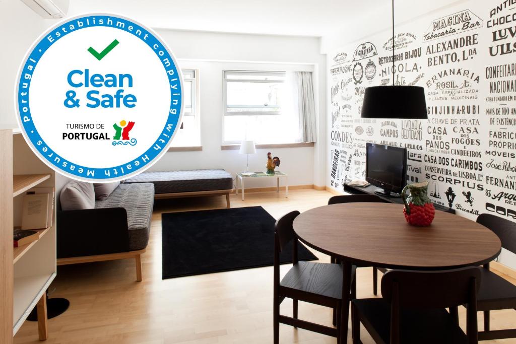 a living room with a sign that reads clean and safe at The Lisbonaire Apartments in Lisbon