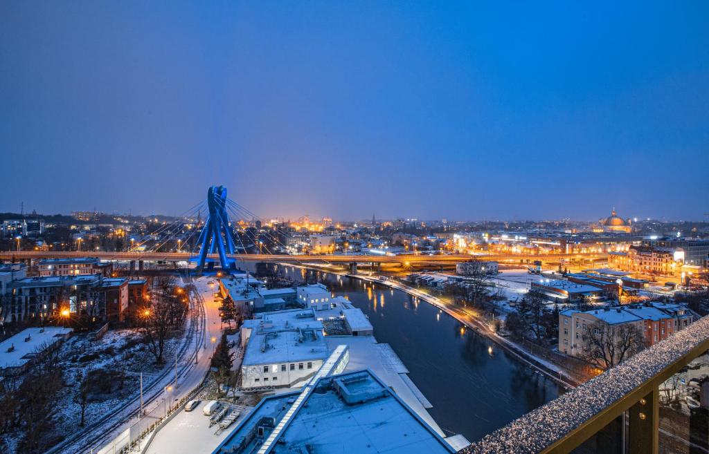 a view of a city at night with snow at E&A Royal Luxury Apartments, Bydgoszcz - SKYLINE in Bydgoszcz