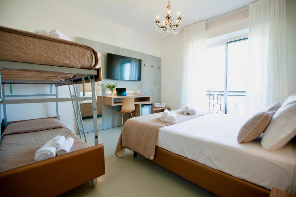 Postel nebo postele na pokoji v ubytování Hotel Maestri