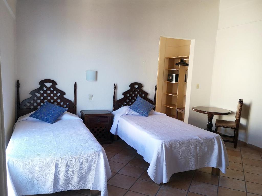 Postel nebo postele na pokoji v ubytování Hotel El Pescador