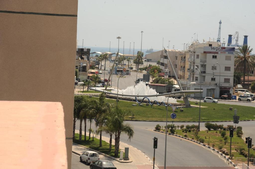 a view of a city with a fountain and a street at Elysso Apartments in Larnaca