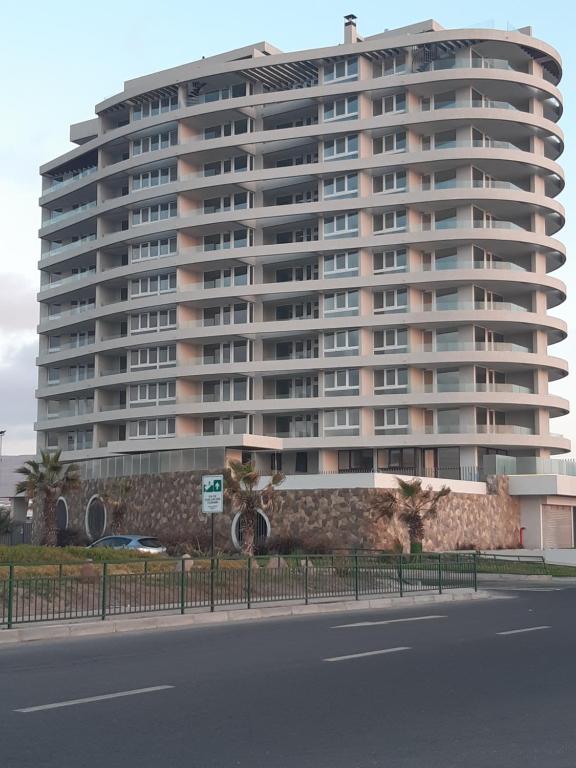 a large apartment building in front of a street at Pacifico 802 in Arica